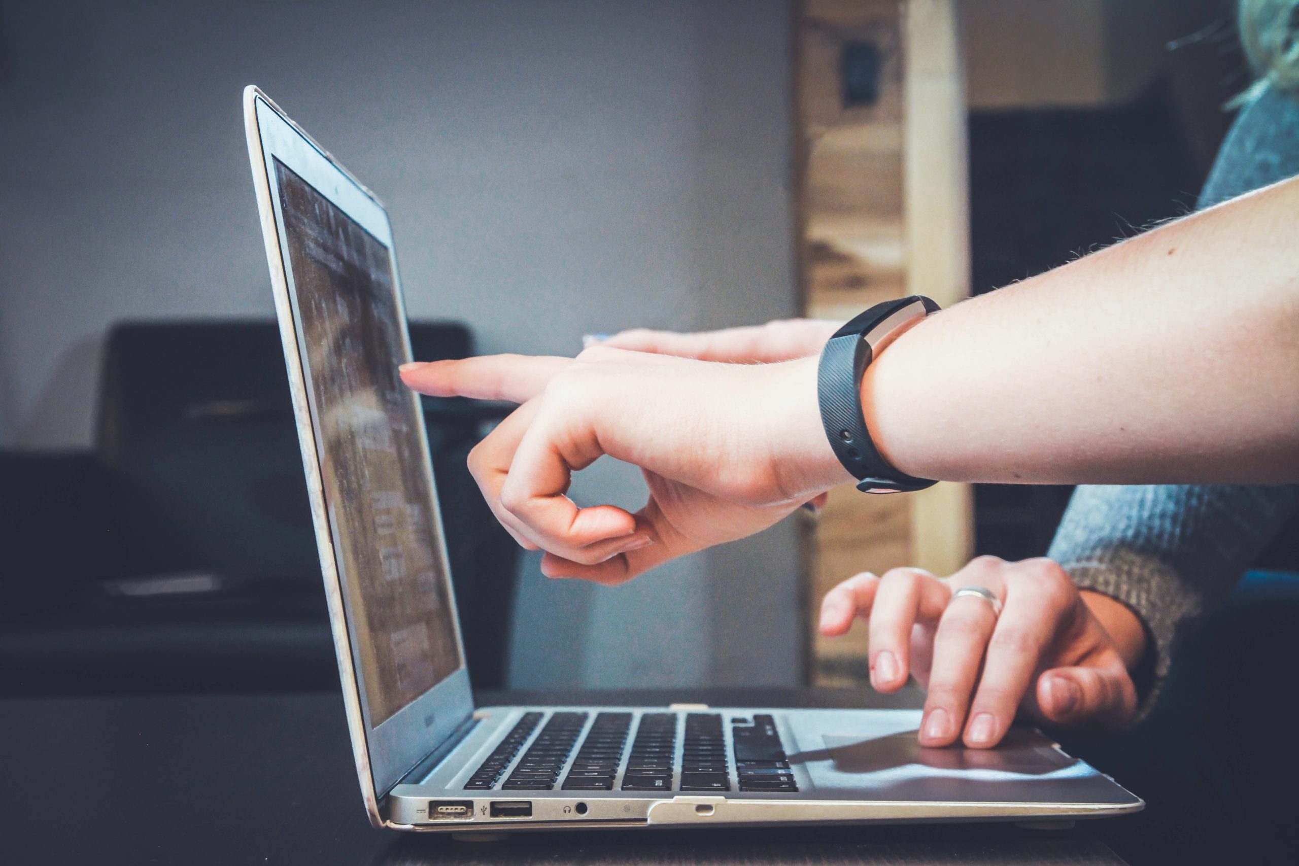 Two people using computer